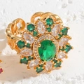 Golden flower ring with green oval zircon and white gemstones on a chain-link band - Green Flower