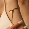 Adjustable gold bead bracelet with polished heart pendant worn on wrist for women - Spiral Textured Beads (I214) / Gold