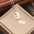 Close-up of silver envelope necklace with removable card engraved Te quiero - Te quiero Engraved / Silver