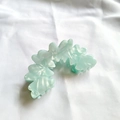 Detail of mint green marble acetate hair claw clip with wave pattern on white fabric - Emerald Green