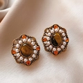 Detailed close-up of vintage gold earrings with tiger eye stone and pearls on beige fabric - Retro Palace Style Hollow Pearl Tiger Eye Studs (925 Sterling Silver Earring Post)