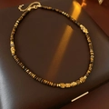 Detail of square tiger eye stone necklace with gold beads and lobster clasp closure - Brown
