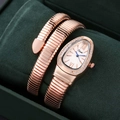 Detailed view of rose gold snake-shaped wrap watch with crystal bezel on green velvet - Rose Gold White
