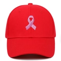 Detailed close-up of pink ribbon embroidery on a red hard-top baseball cap for sports - Adjustable / Red