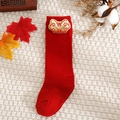 Detail of red baby sock with golden Ji-Xiang embroidery and festive knitted texture - Red-Auspicious
