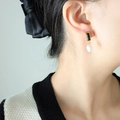 Orecchini di perle barocche con gemma nera e montatura dorata indossati da modella - Oro Zirconia Nera