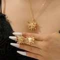 Macro detail of punk urchin starburst jewelry set with gold necklace and rings - Sea Urchin Style Necklace & Ring Set / Two-Piece Set / Gold