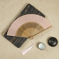 Pink silk folding fan with bamboo frame and matching tassel on a vintage wooden background - Pink / 23CM