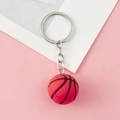 Red basketball keychain with silver metal ring and textured surface on pink background - Silver Chain Style-Basketball