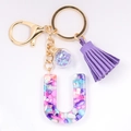 Detail of resin letter U keychain with colorful crushed stones and purple tassel - Letter U