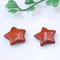 Polished red natural stone star ornaments with smooth texture on white background - Red Jasper