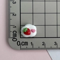 Close-up of a pink resin cloud accessory with strawberry detail showing dimensions on a ruler - Strawberry Cloud-Red Pink White