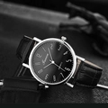 Close-up of black quartz watch face with silver case and crocodile texture leather strap - Black Dial Black Strap with Numerals