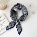 Blue and white paisley pleated silk scarf tied in a knot on a white minimalist table - Paisley Floral Border Navy