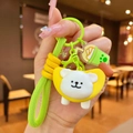 Close-up of a cute puppy keychain with green braided strap and boba tea charm - Yellow Banana Headgear Dog