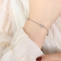 Elegant silver-tone chain bracelet featuring petite heart charms and sparkling zircons - Bracelet / 15+5cm / Steel
