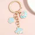 Golden keychain with light blue shell, jellyfish and shark pendants with pearls - Light Blue Jellyfish Shark