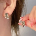Macro shot of gold star butterfly stud earrings with zircon inlay showing glitter effect - Gold Textured Glitter Round Stud Earrings (2650)