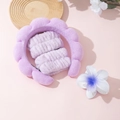 Detailed view of light purple sponge headband and matching plush wristbands for skincare - Purple Headband Wristbands And Plumeria Clip