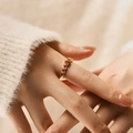Detail of adjustable gold ring with heart-cut rubies and white zirconias on finger - Adjustable Open / Red (KR0044-3)