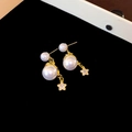 Elegant gold earrings with double pearls and a zircon star pendant on a black background - Silver Earring Post Style / Gold