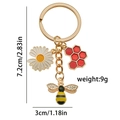 Cute bee keychain with daisy and red hexagon honeycomb pendant in gold finish - Daisy Bee