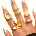 Set of eight gold bohemian rings featuring moonstone gems and irregular molten textures - Gold