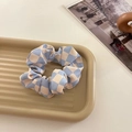 Blue and white checkerboard scrunchie on a decorative tray with minimalist styling - Blue Plaid