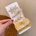 Detail of 5-piece hair clip set featuring rhinestone starfish, mesh bow and pearl accents - Starfish Yellow Mesh 5-piece Set