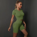 Detailed side view of seamless dark green yoga set featuring crop top and high waist shorts - Army Green