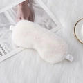 Creamy white plush sleep mask with silky elastic strap on a cozy soft background - Off White