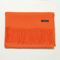 Detail view of smooth orange cashmere scarf with soft fringes on a white background - 70cm / Orange