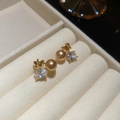 Dettaglio macro di orecchini a farfalla placcati oro 18K con perle champagne e zirconi - Stile Perla Farfalla / Oro champagne