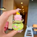 Close-up of pink pig miniature inside a liquid drift bottle with colorful glitters - Peach Pig / Luminous Snowflake Peach Pig - Yellow