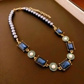 Detail of double-layer necklace with dark grey pearls and blue gemstones in gold setting - Style 7 Gold Blue