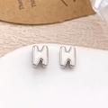 Polished silver H-shaped stud earrings displayed on a white ceramic tray with a minimalist look - Silver Letter N