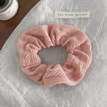 Detail of pink knitted scrunchie with waffle texture on white aesthetic background - Pink