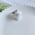 Cute white flocked puppy dog keychain with silver lobster clasp on a ceramic tray - Blushed Style 1