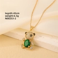 Detailed close-up of crystal teddy bear pendant with green stone on 45cm gold chain - Gold - Green Oval Stone Bear