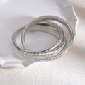 Détail du bracelet extensible multicouche en métal argenté sur plateau en céramique - Bracelet élastique enveloppé à plusieurs tours argenté