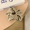 Korean style scrunchie in vintage brown checkered pattern on a wooden background - Light Plaid