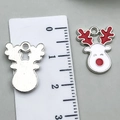 Christmas reindeer alloy charm with white face and red antlers shown on scale - Christmas Reindeer 17x14mm