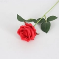 Single artificial red velvet rose with green stem and leaves on white background - Silk Cloth Rose / Silk Bright Red