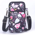 Mini floral crossbody phone bag with black floral fabric and adjustable shoulder strap - Black Vine
