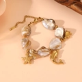 Detailed view of beach-themed bracelet with gold charms of turtle, starfish and dolphin - Dolphin Bracelet