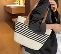 Summer woven tote bag with black stripes and brown leather handles on a female model - Black Leather Strap/Striped / Off White