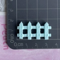 Top-down view of a light blue mini resin fence DIY accessory on a metric measurement mat - Blue Fence / Shiny Blue