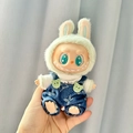 Labubu plush toy in light green rabbit hat and blue denim overalls with vinyl face - White Labubu T-shirt + Designer Overalls / First And Second Generation Keychains Are Compatible With La Cloth Dolls. Dolls Not Included.