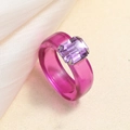 Close-up of pink resin ring featuring a purple rectangular gemstone on silk fabric - One Size / Purple