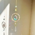 Crystal suncatcher with gold geometric frame and natural stones creating rainbow reflections - White Crystal